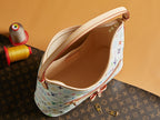 Multicolor monogram handbag open interior with zippered pocket and leather trim