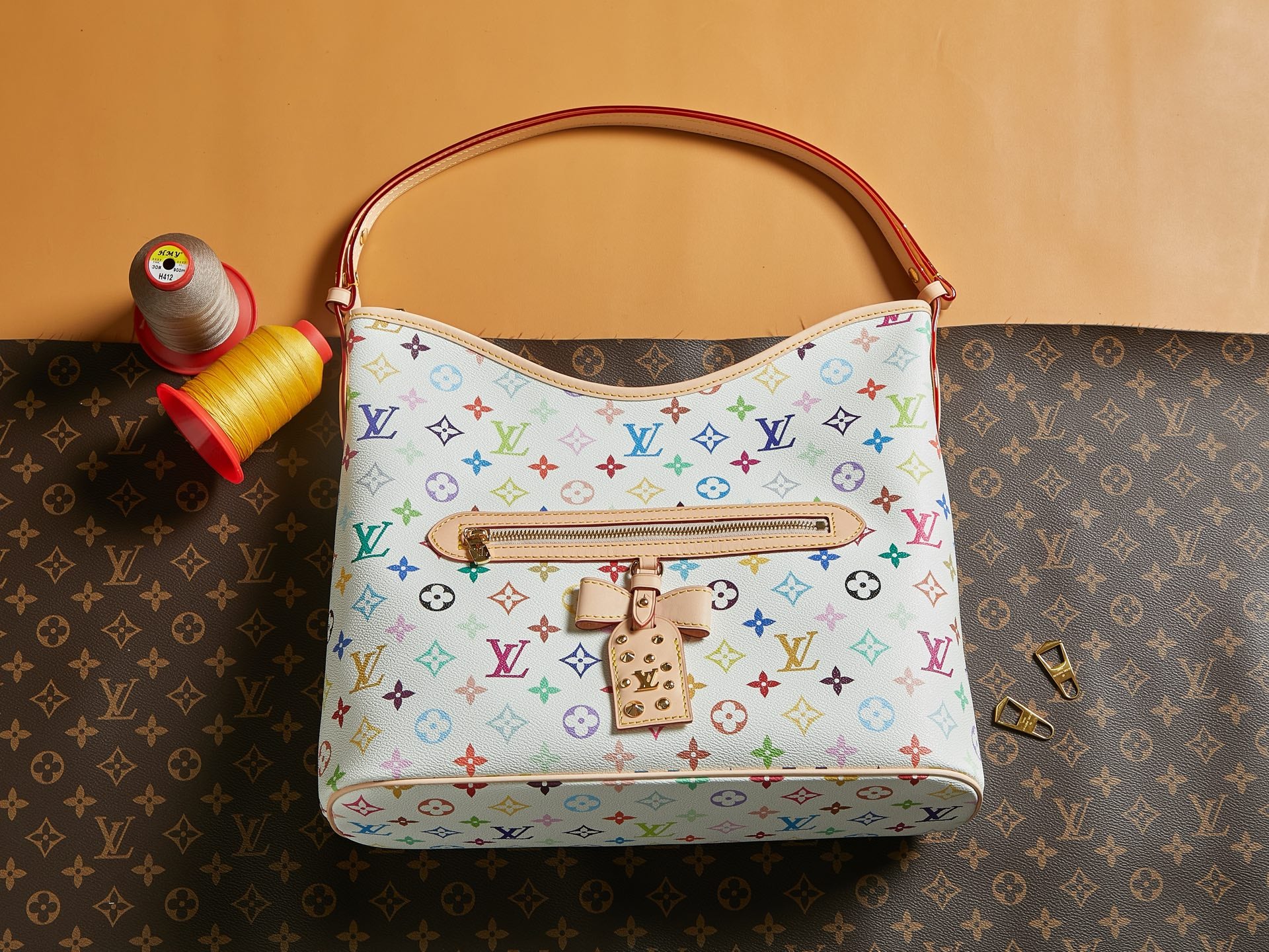 Louis Vuitton multicolor monogram handbag with top handle and front snap clasp