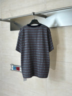 Patterned short-sleeve T-shirt with dark stripes, small motifs, and red edging