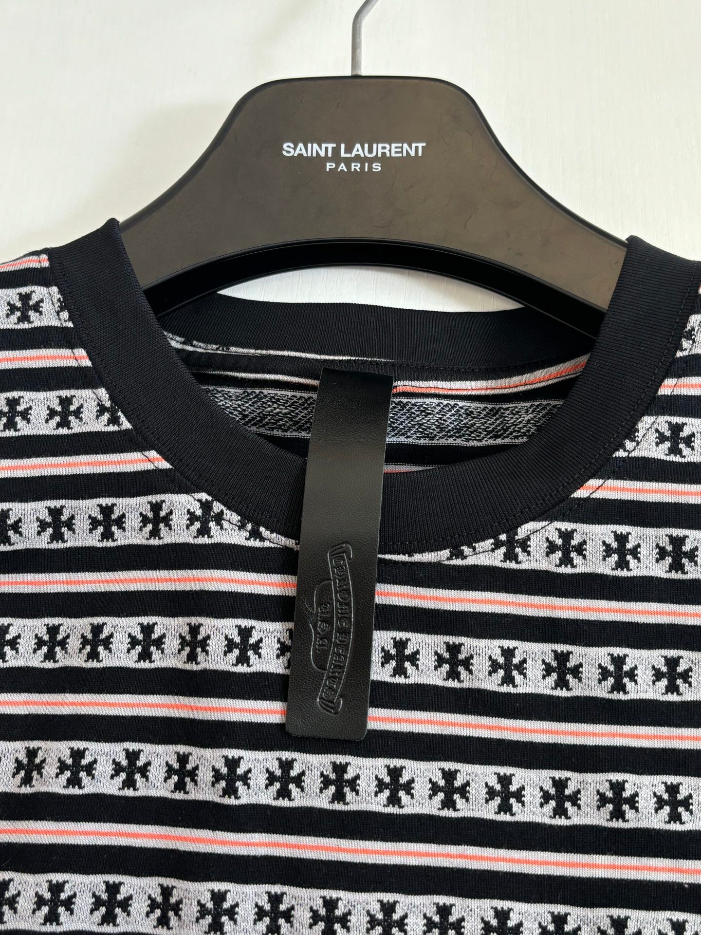 Crew-neck T-shirt neckline with black collar and black-and-white striped knit