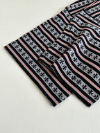 Laid-flat striped T-shirt with black-and-white bands and thin red stripes