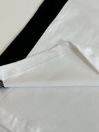 Balenciaga jersey hem close-up with white fabric and black side stripe