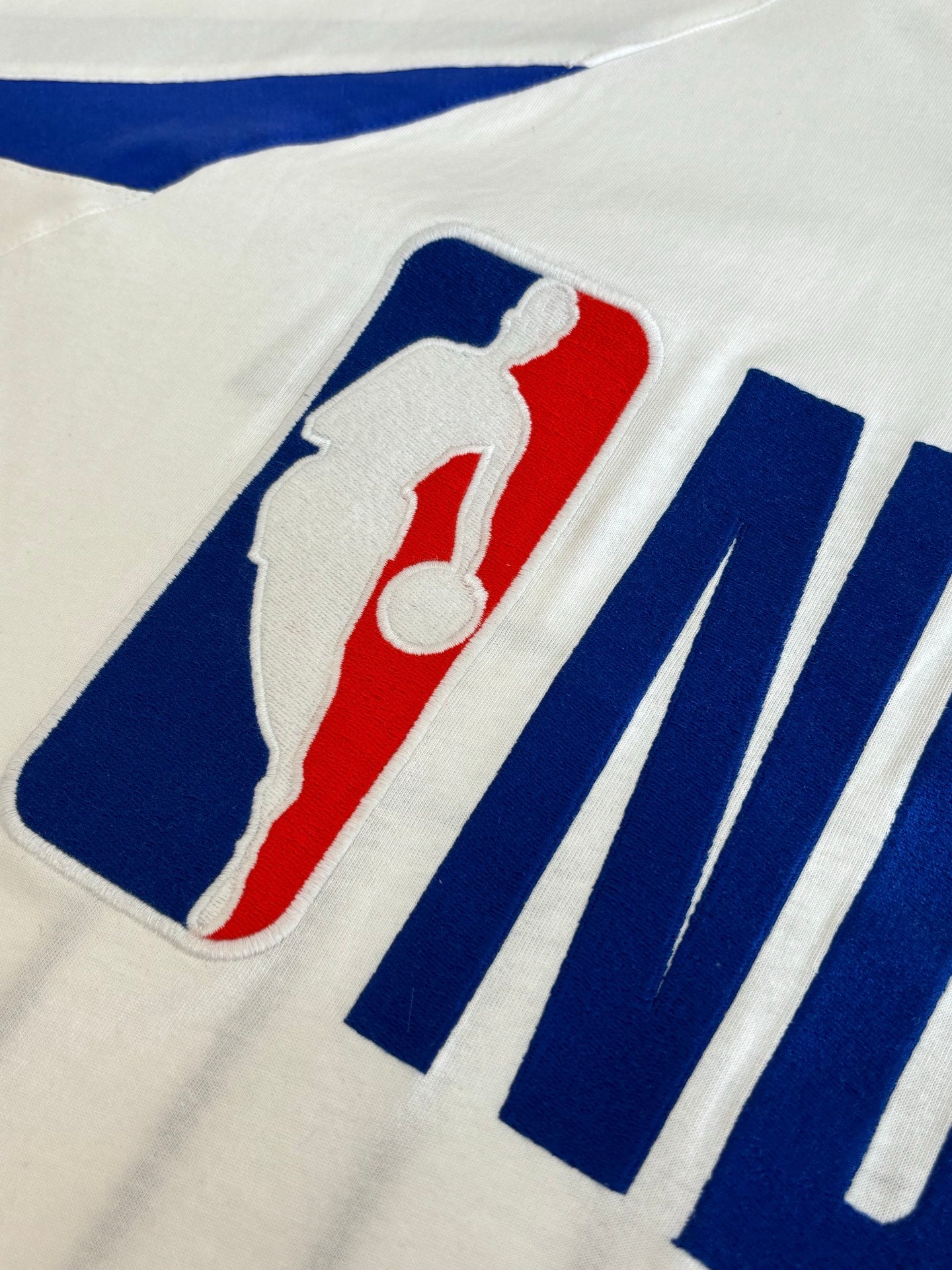 Balenciaga jersey graphic close-up with basketball player artwork and blue stripe