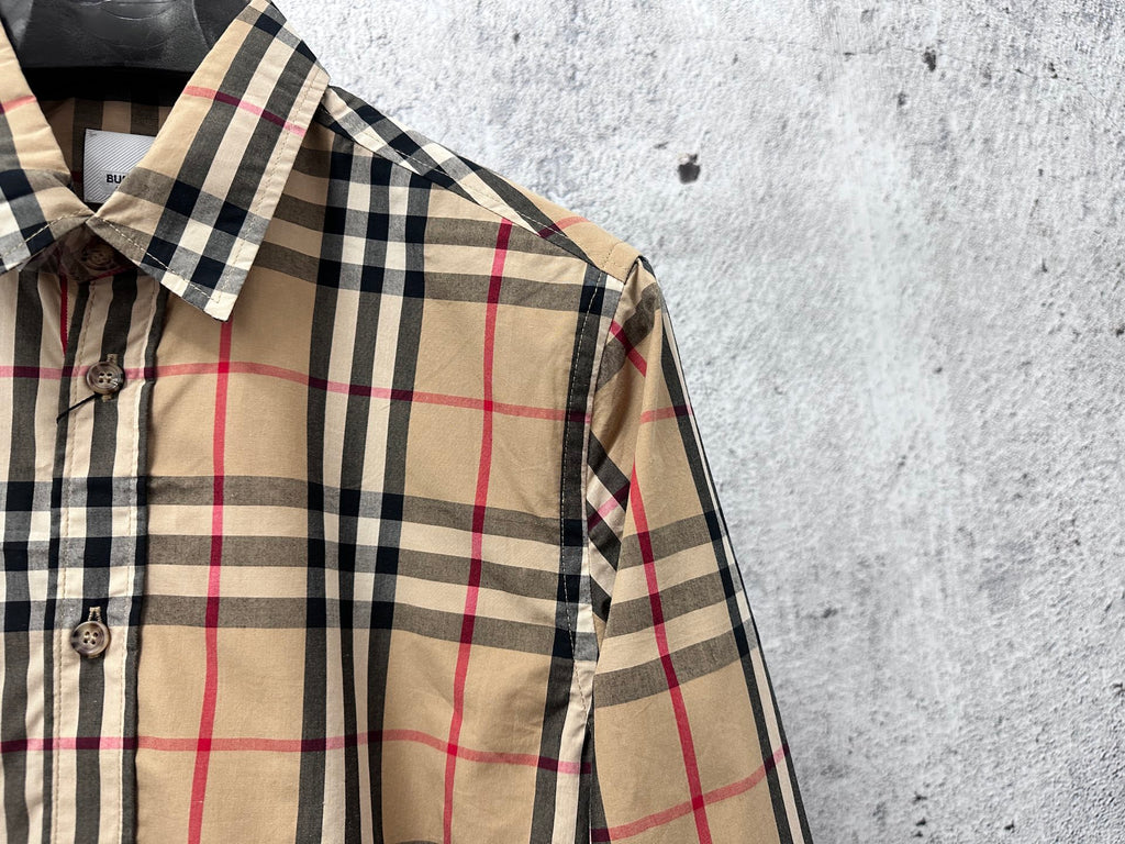 Burberry plaid button-up shirt collar and shoulder detail in beige, navy, and red