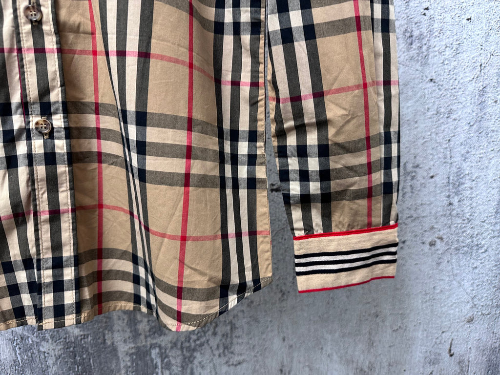 Burberry plaid shirt sleeve and cuff detail in beige with navy, red, and striped trim