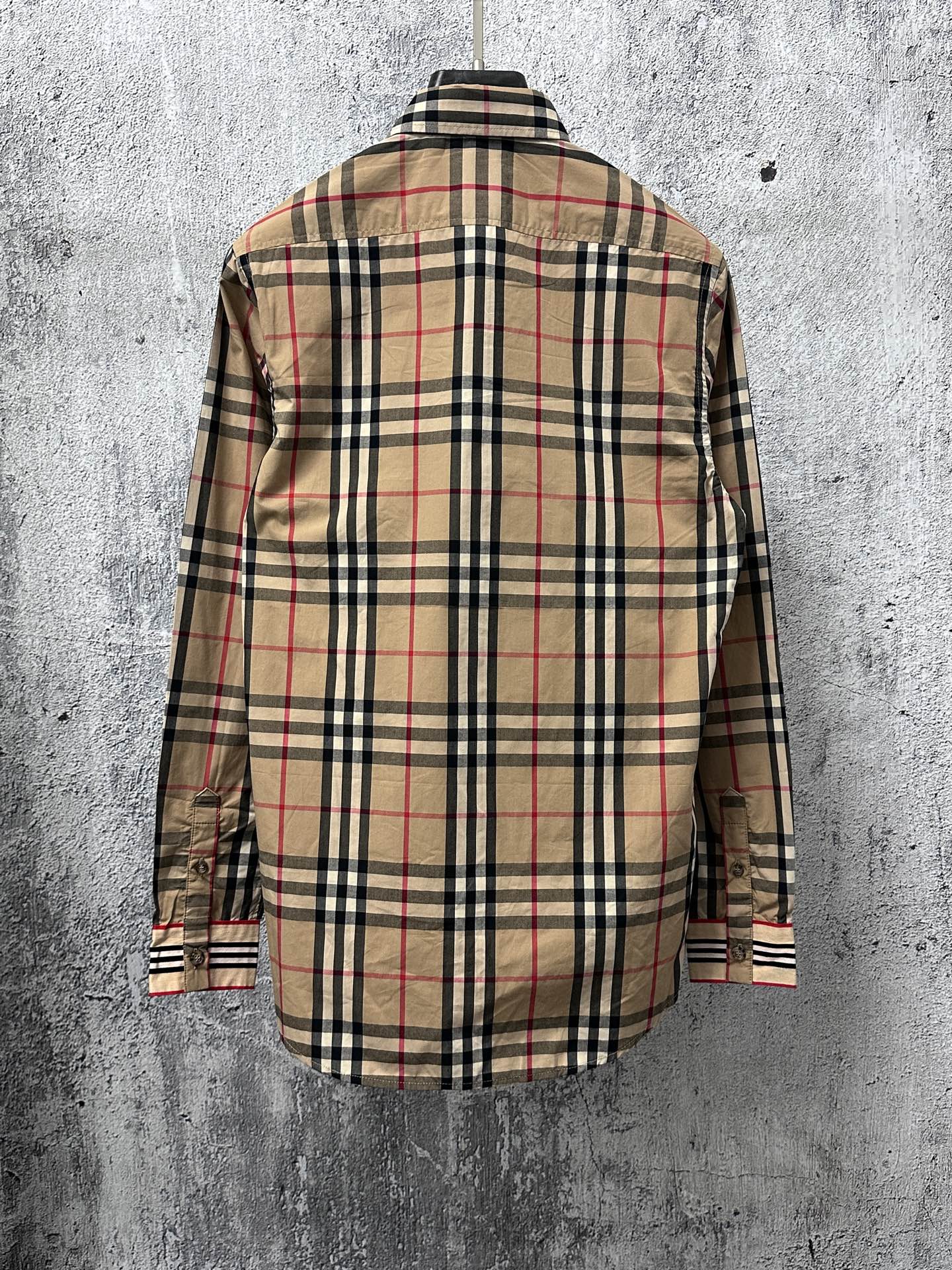 Plaid long-sleeve button-up shirt, back view, black tan and red checks