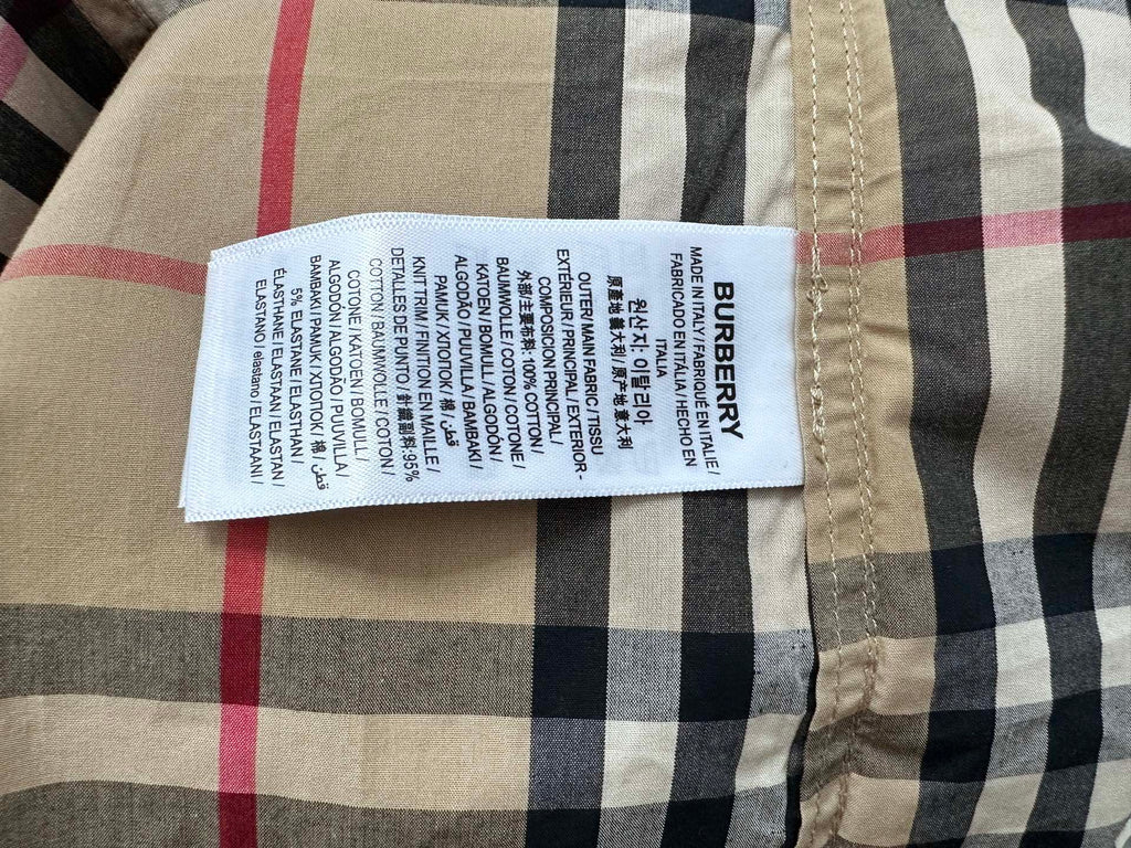 Burberry care label on beige plaid button-up shirt with navy and red stripes