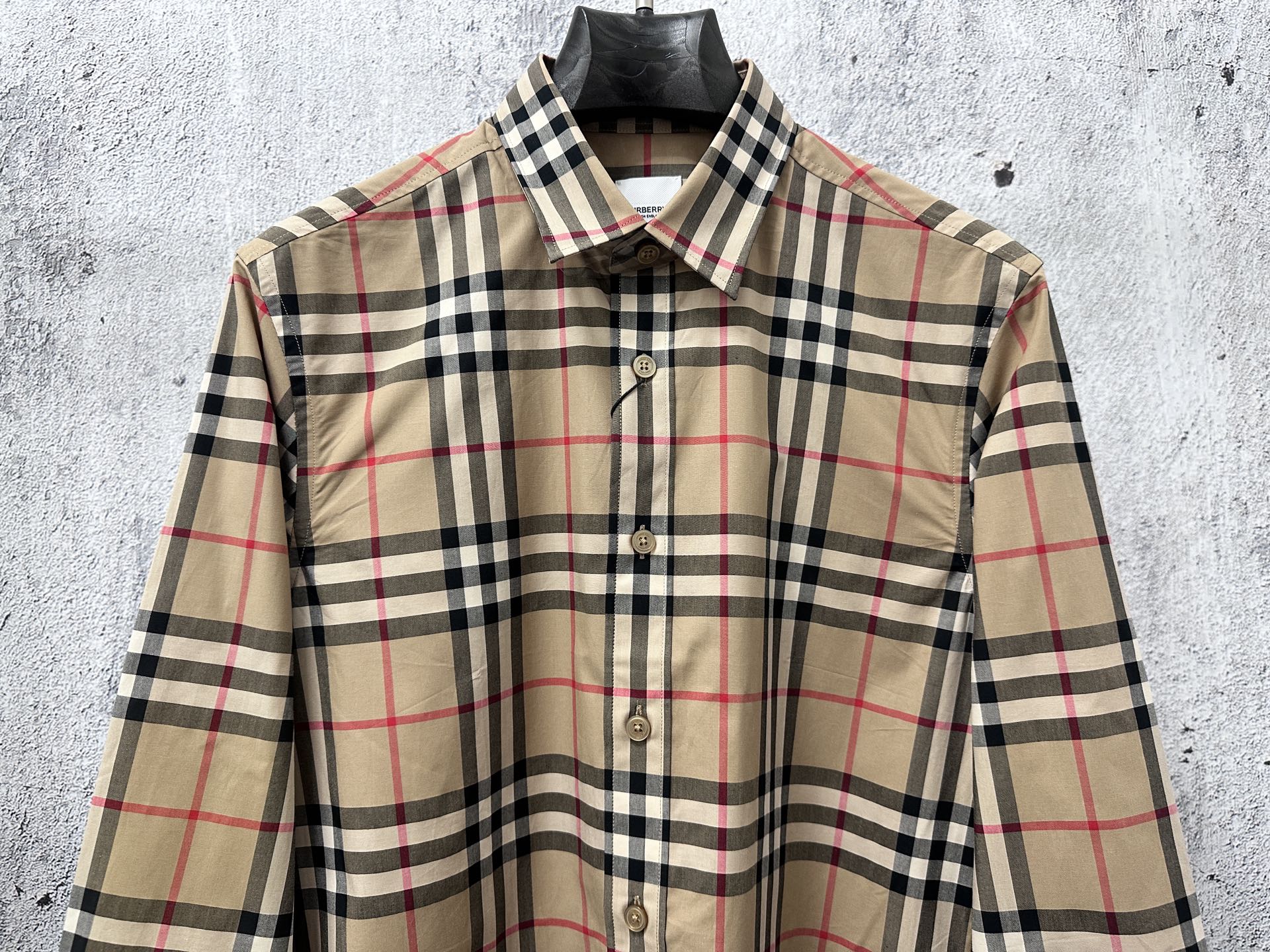 Plaid button-up shirt front view with button placket and long sleeves