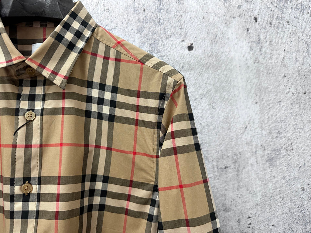 Plaid button-up shirt shoulder and collar detail with long cuff