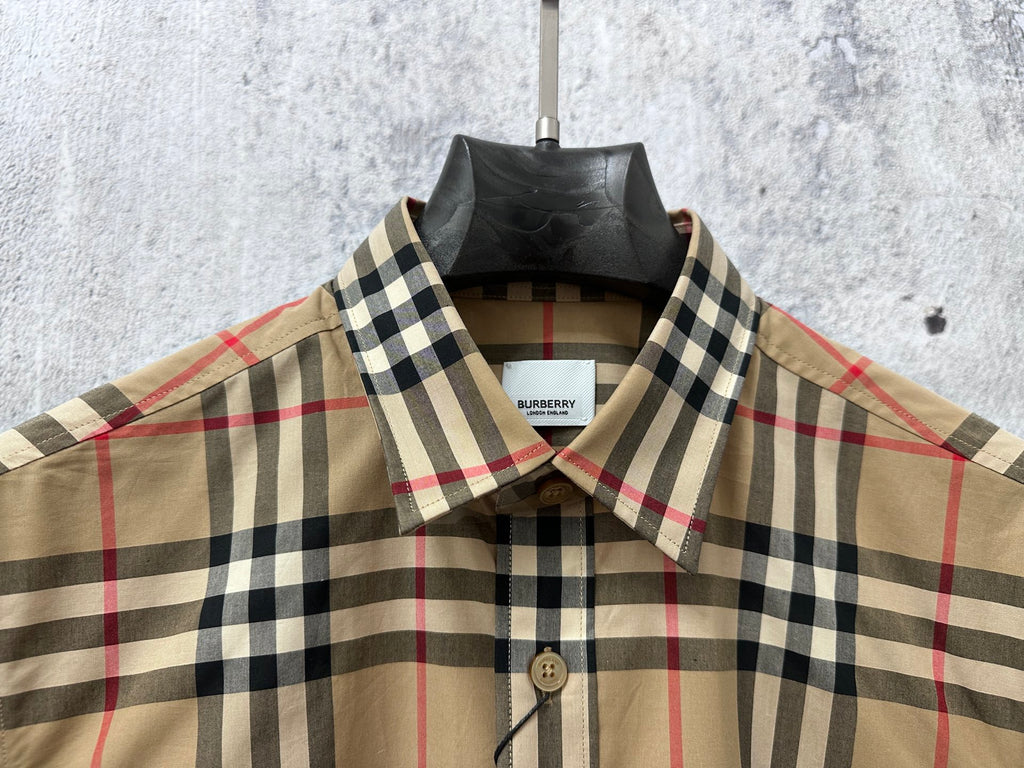 Plaid button-up shirt with pointed collar and button front, visible brand label