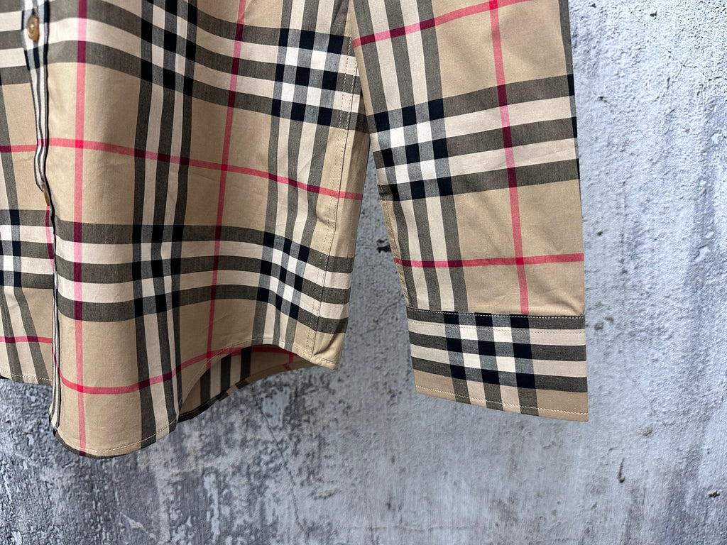 Plaid shirt hem and sleeve detail with buttoned cuff