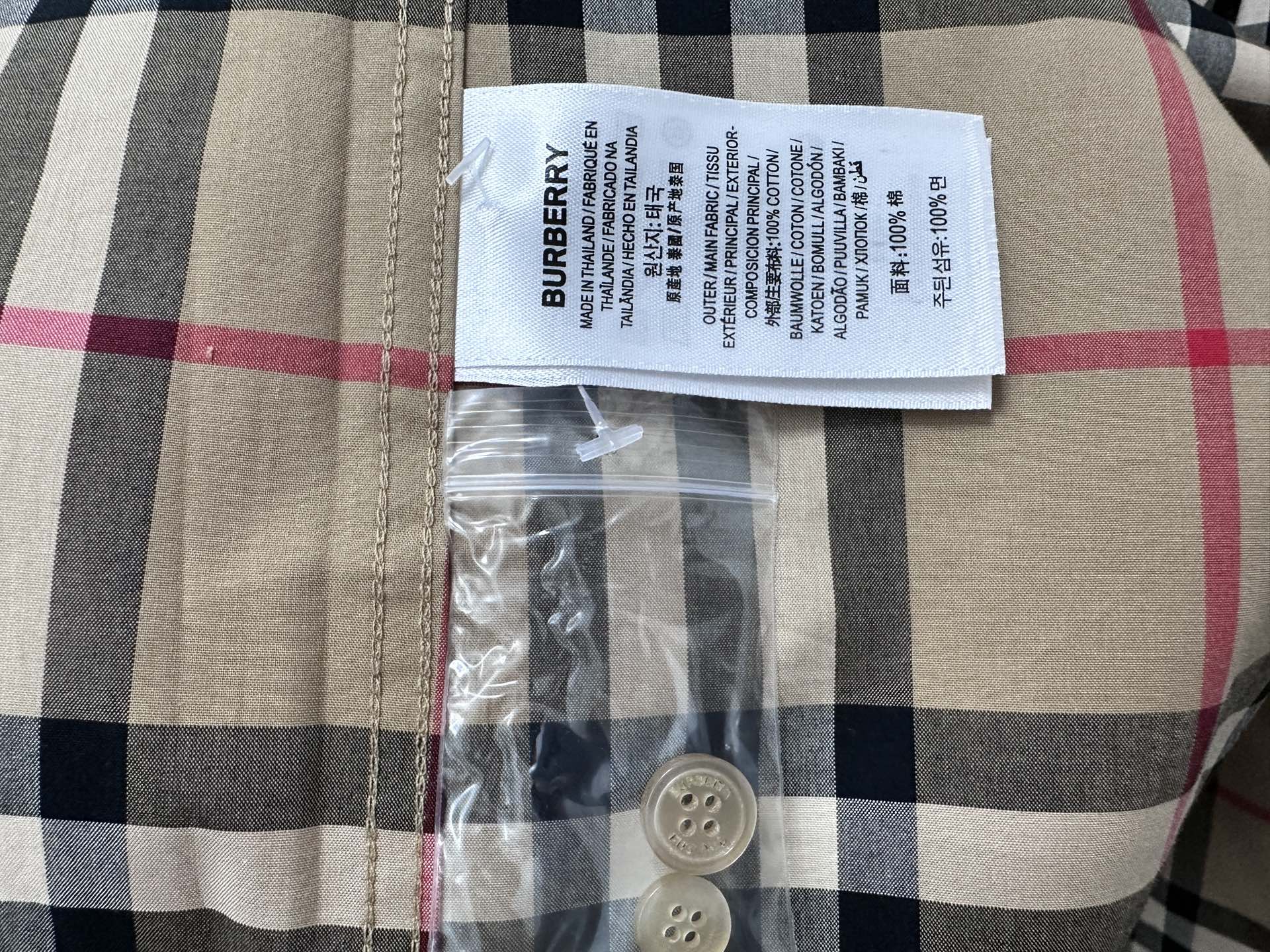 Burberry size tag and button detail on plaid shirt