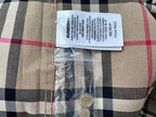 Burberry plaid shirt label on fabric, with care information and logo