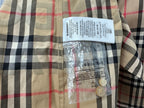 Burberry plaid shirt care label on inner placket with buttons, beige black red check