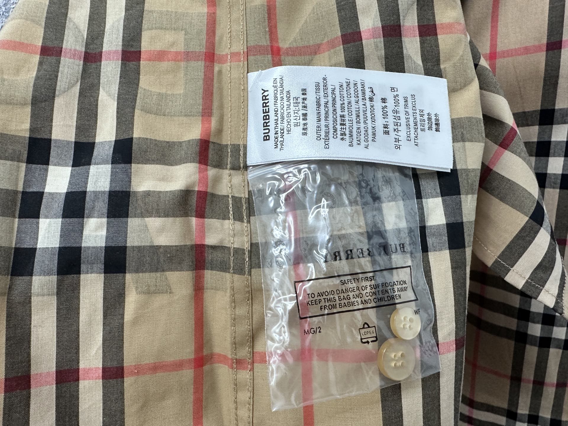 Burberry plaid shirt with hang tag and button at neckline area