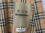 Burberry branded label on check shirt fabric, tan black and red
