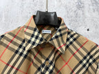 Burberry plaid long-sleeve shirt open collar detail, beige with navy and red plaid.