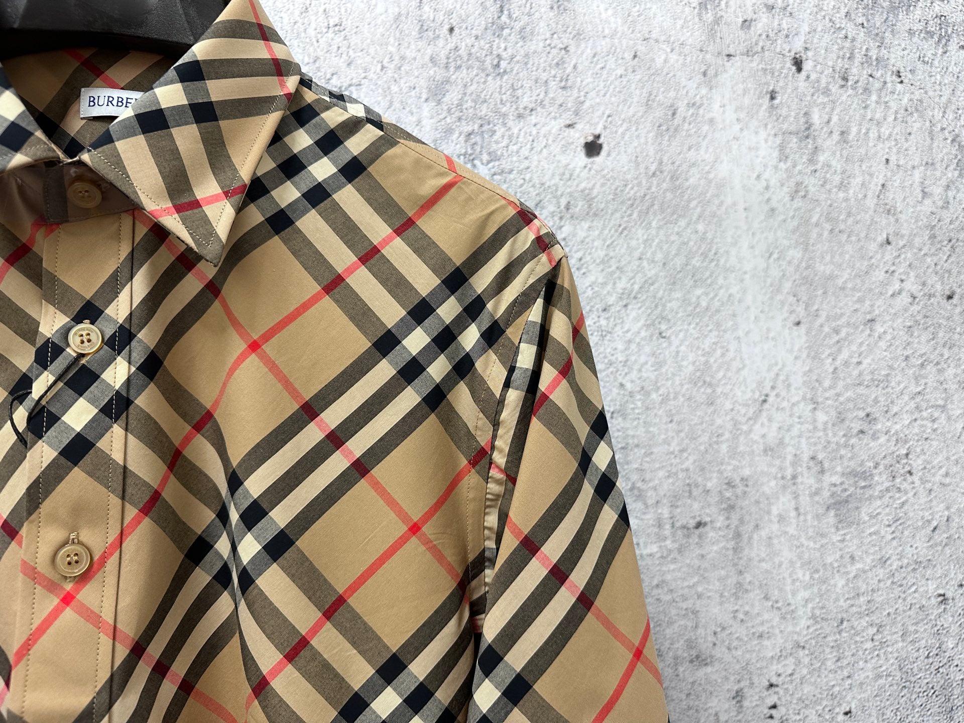 Burberry plaid long-sleeve shirt close-up of collar and button placket, beige black red check