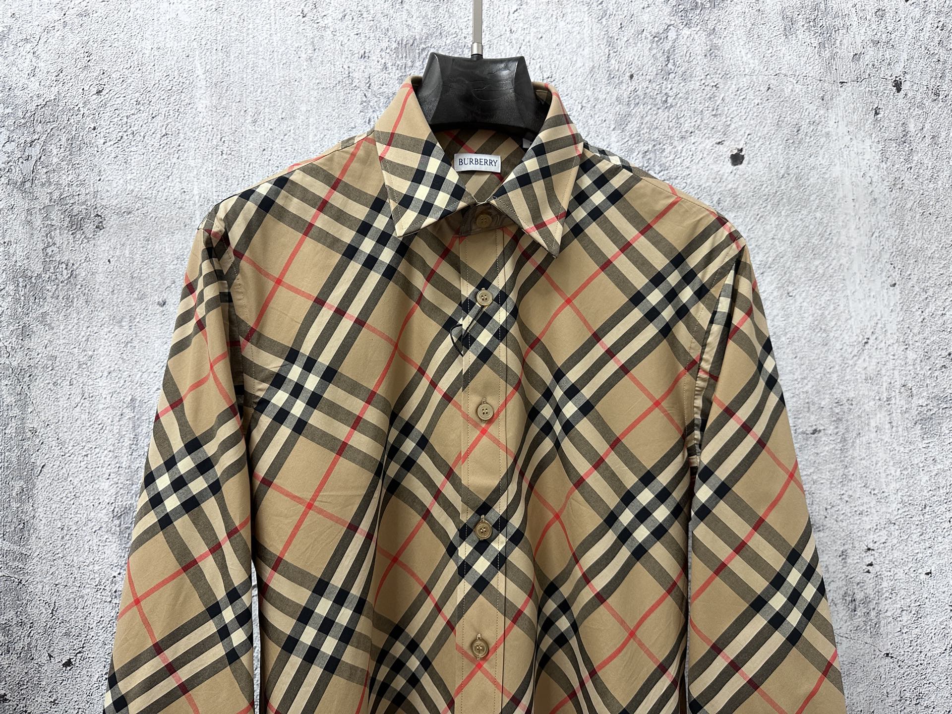 Burberry plaid long-sleeve button-up shirt on hanger, beige base with navy and red lines