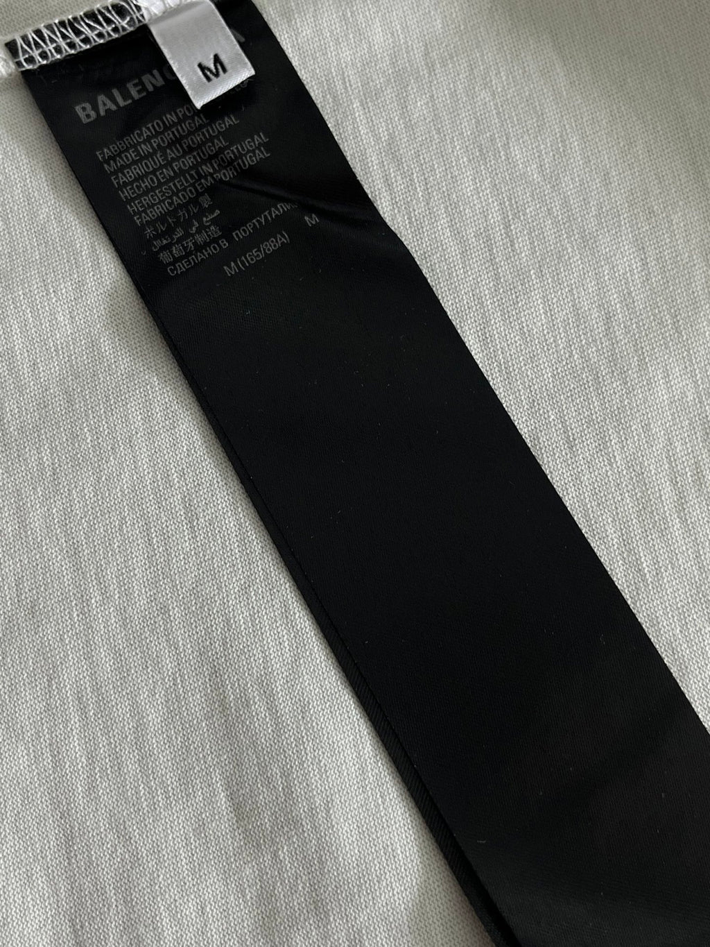 Balenciaga T-shirt size M care label on inside black tag, on light fabric
