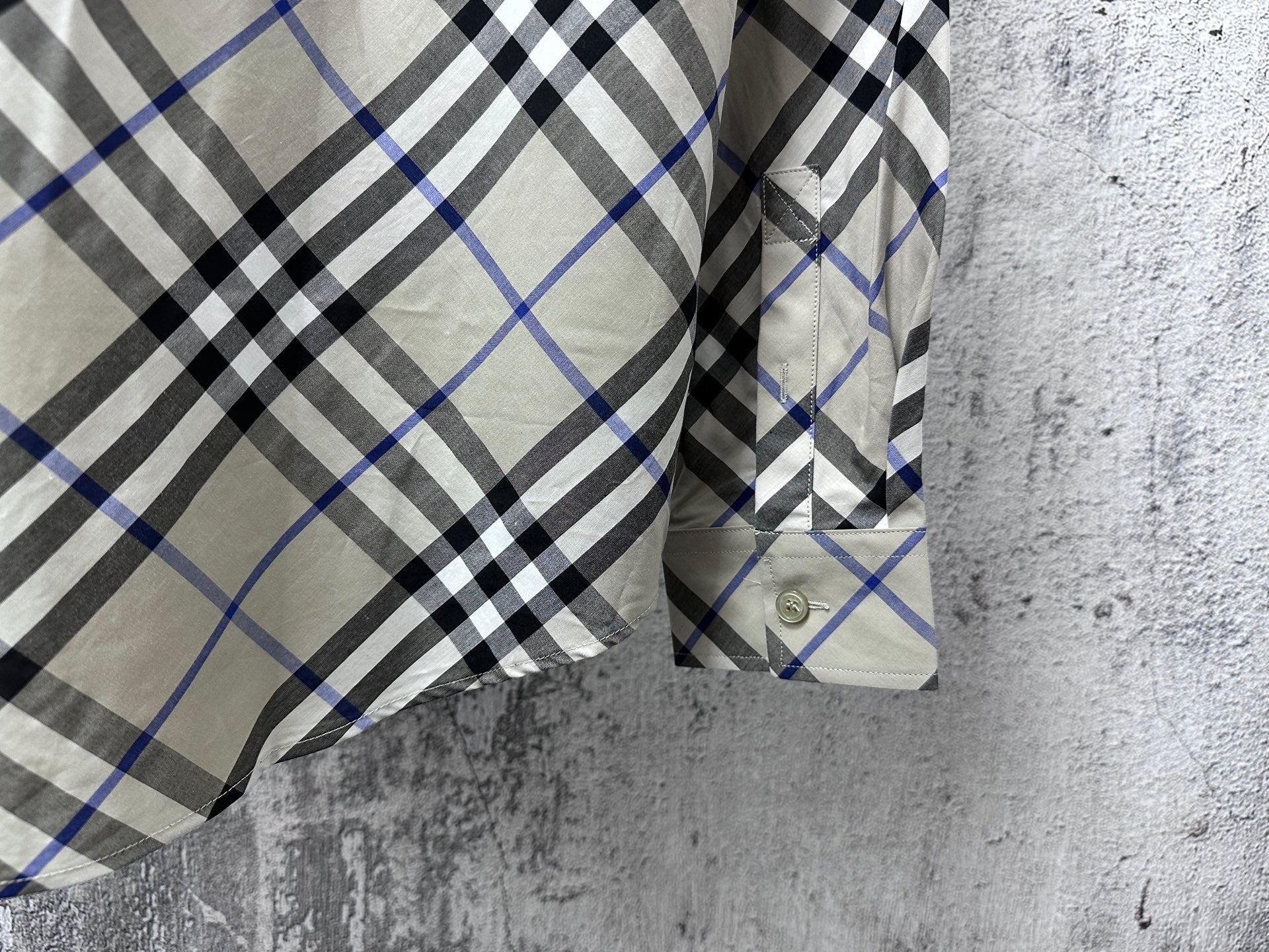 Plaid shirt sleeve cuff and buttoned placket detail