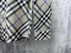 Burberry plaid shirt cuffs and sleeves, buttoned front partially visible
