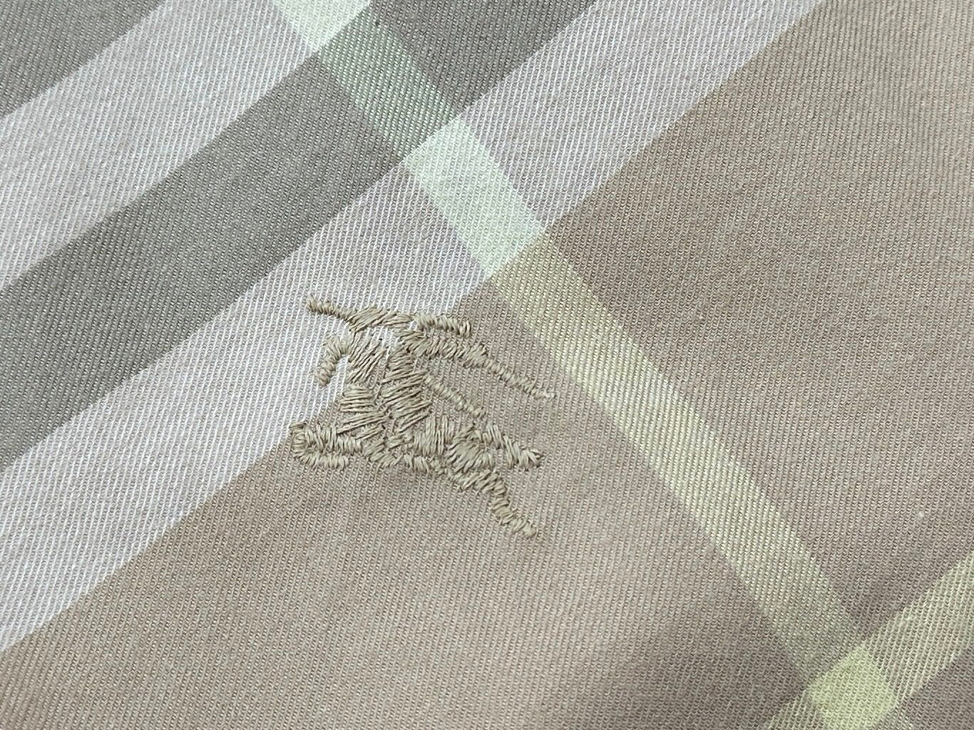 Burberry embroidered emblem on plaid fabric, beige and light gray