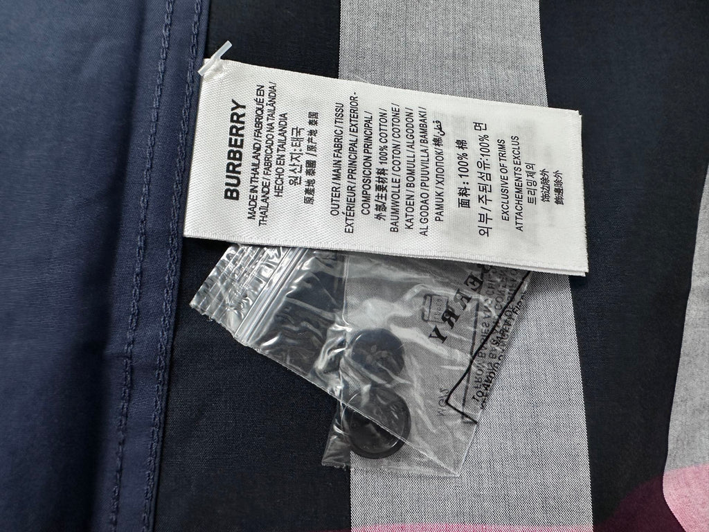 Burberry care label and spare buttons for plaid shirt