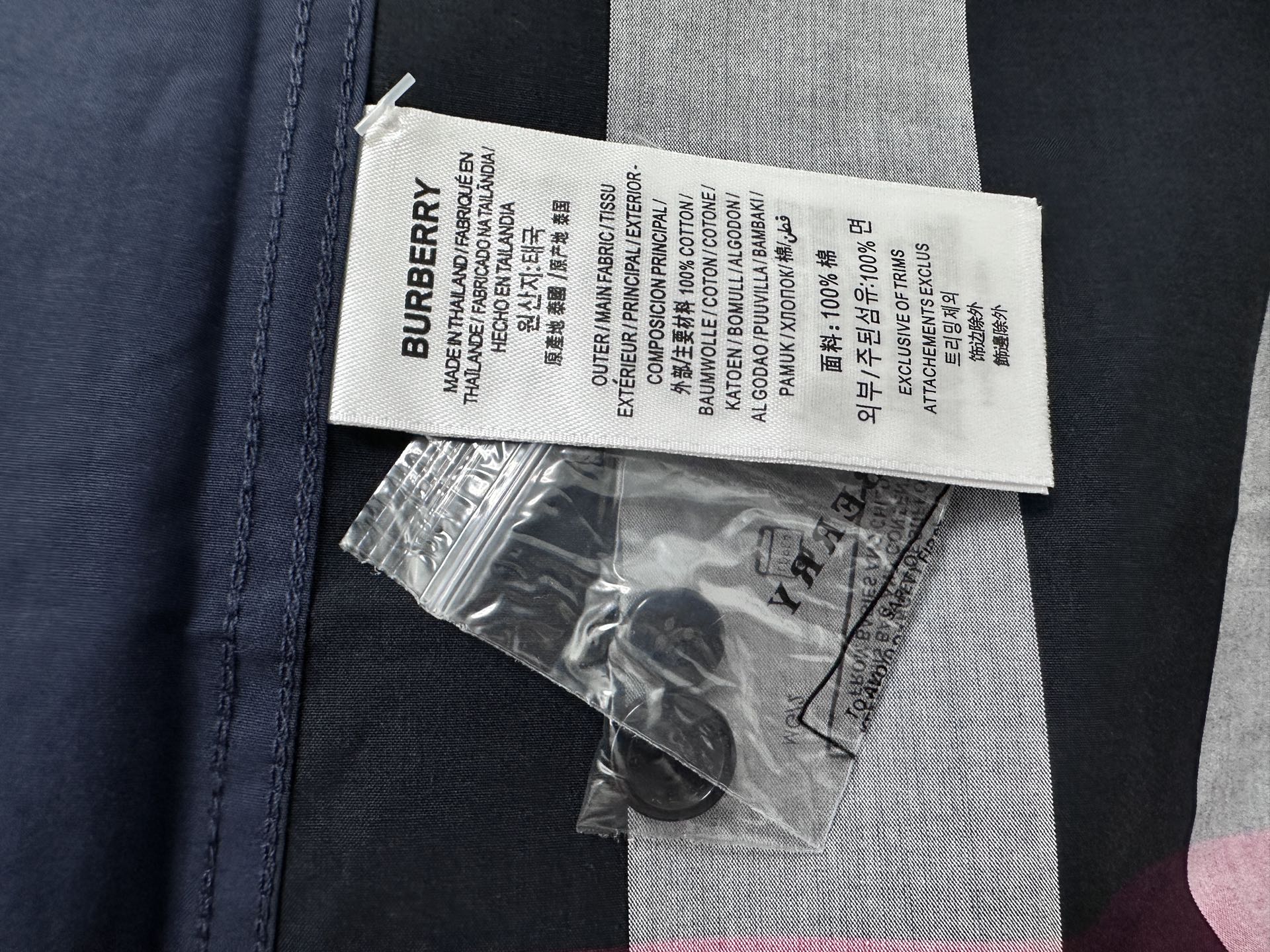 Burberry garment label and care tags on plaid shirt