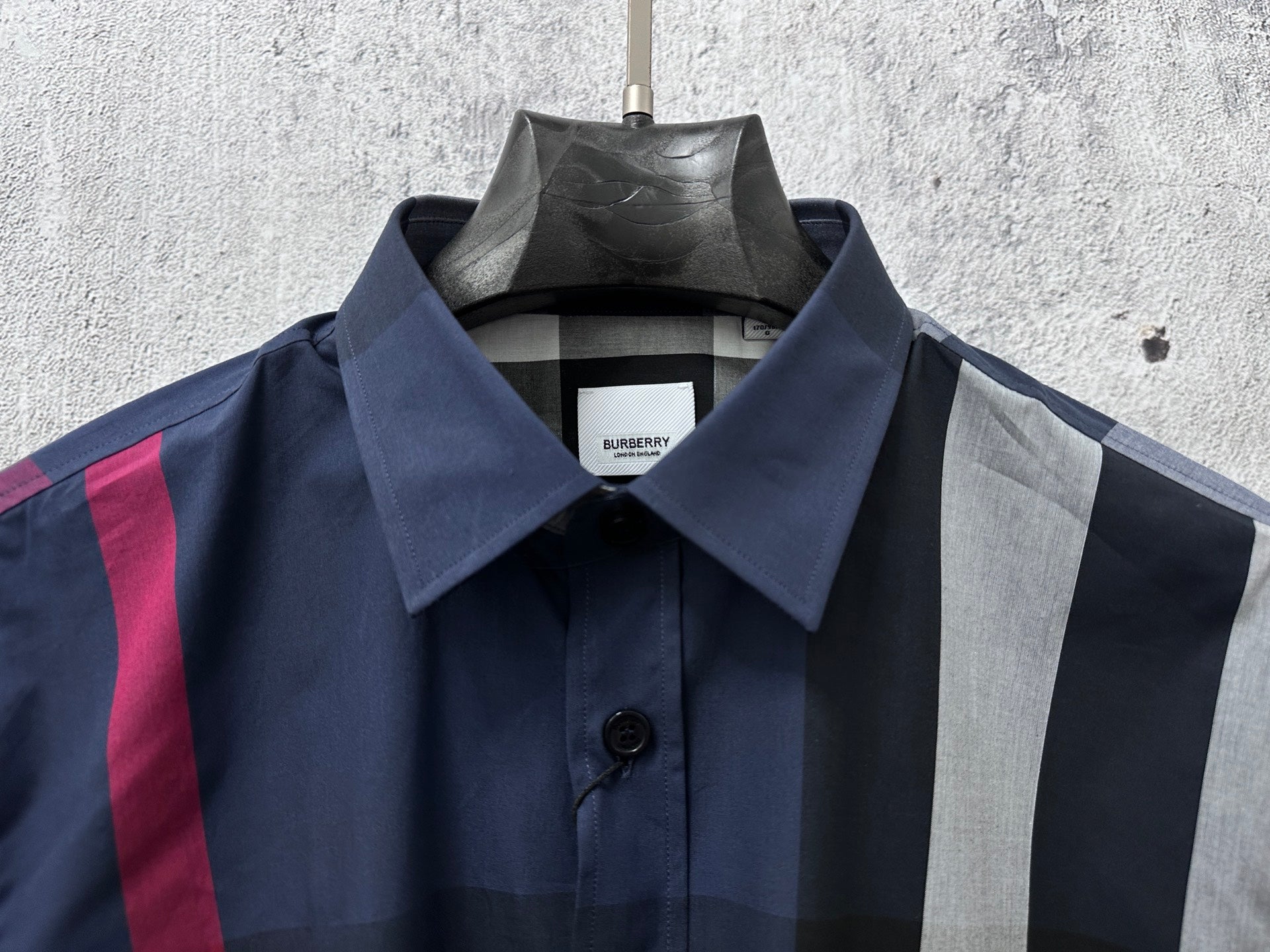Burberry plaid button-up shirt neckline with button and interior tag