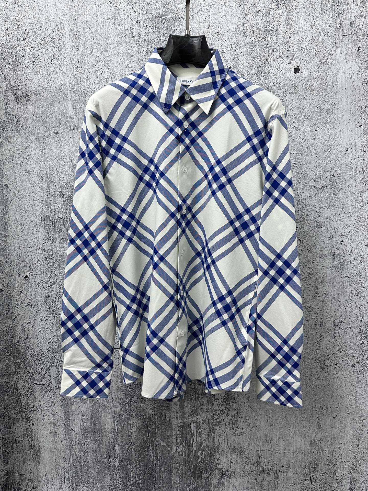 Long-sleeve button-up shirt in blue and cream plaid with pointed collar