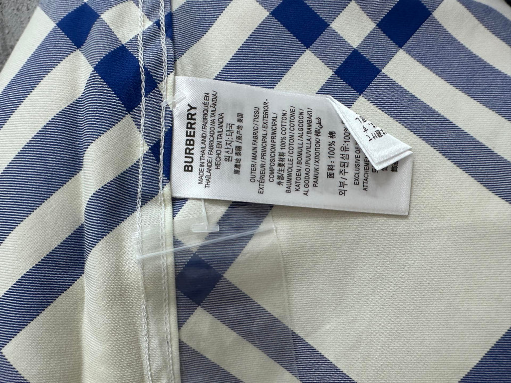 Burberry fabric care label on blue-and-cream plaid shirt