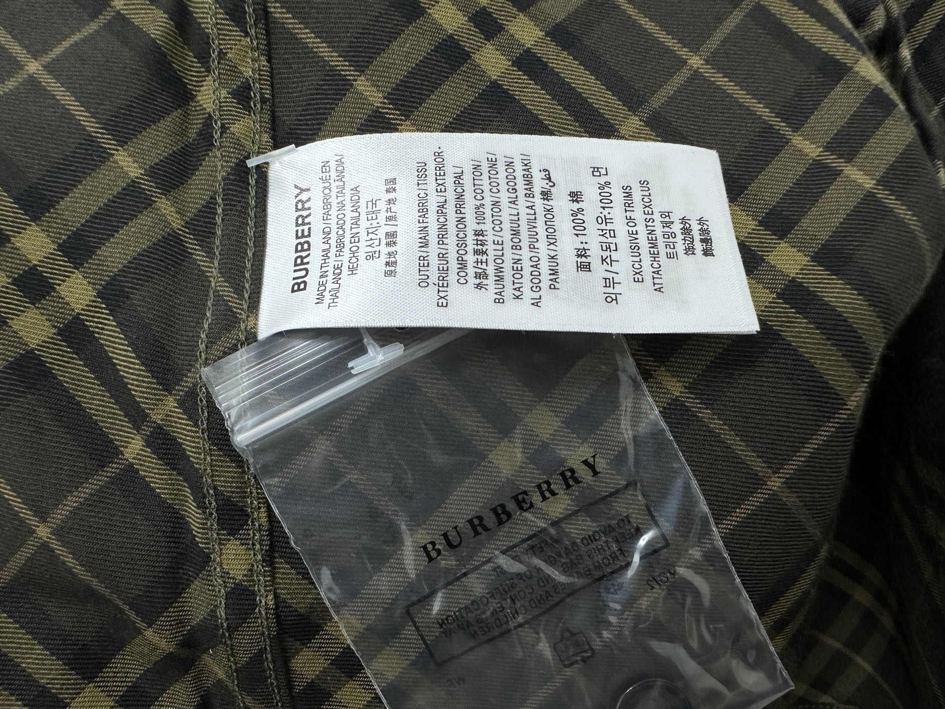 Burberry plaid shirt care label and size tag, dark green with yellow check