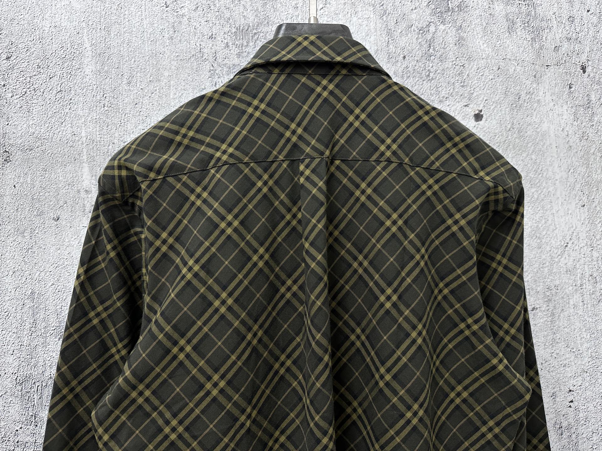Back view of a plaid button-up shirt in dark green with yellow grid lines