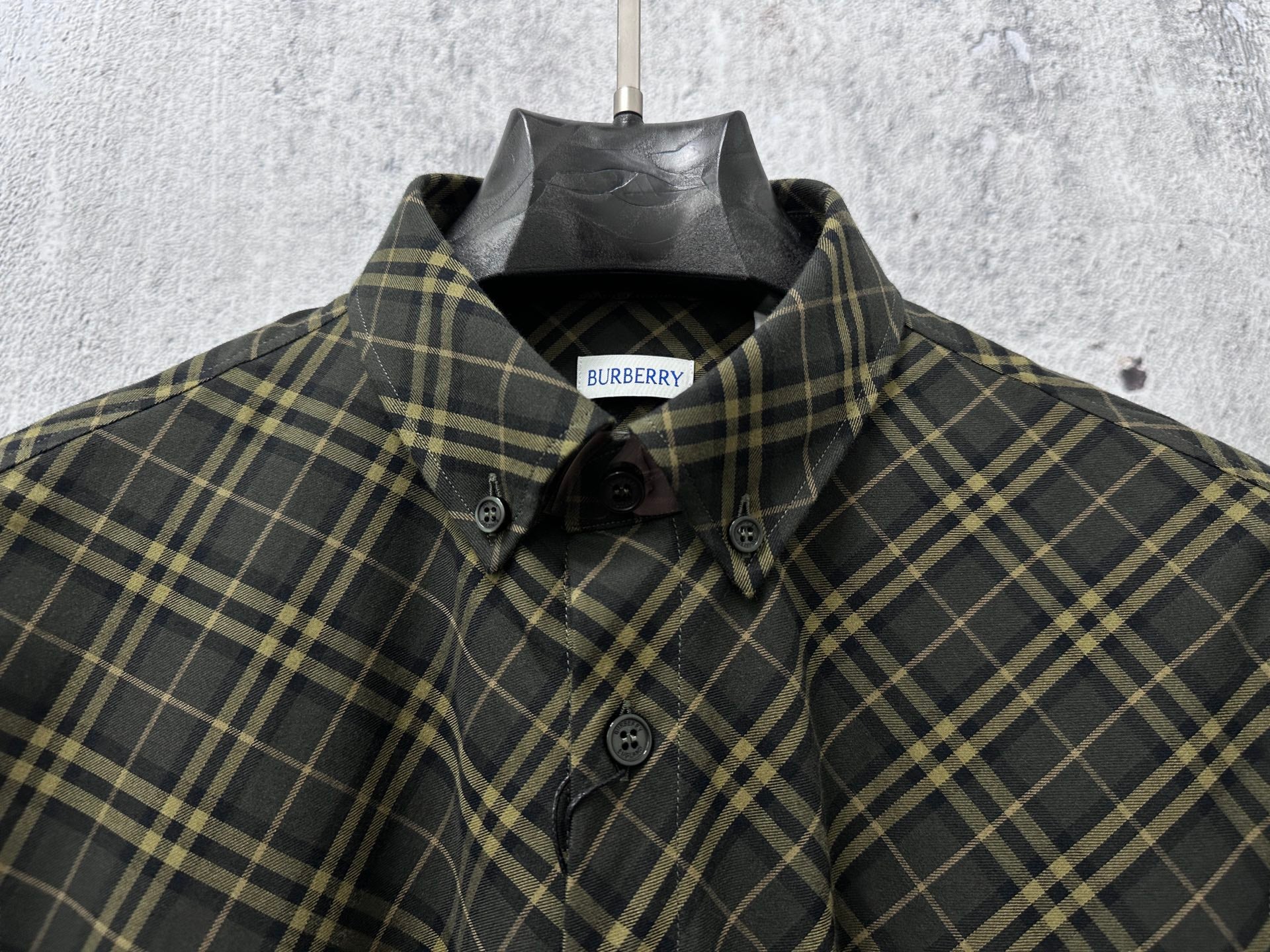 Burberry plaid button-up shirt with collar, front buttons, and logo label
