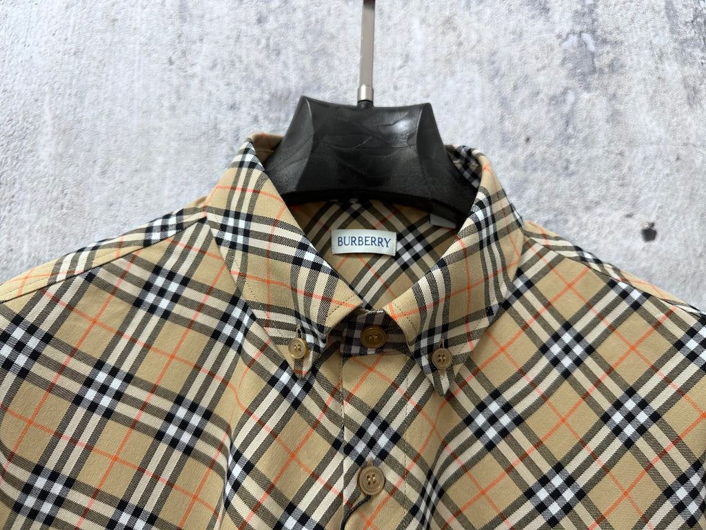 Burberry plaid shirt front close-up with embroidered crest and buttons