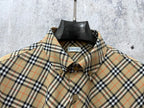 Burberry plaid shirt front close-up with embroidered crest and buttons