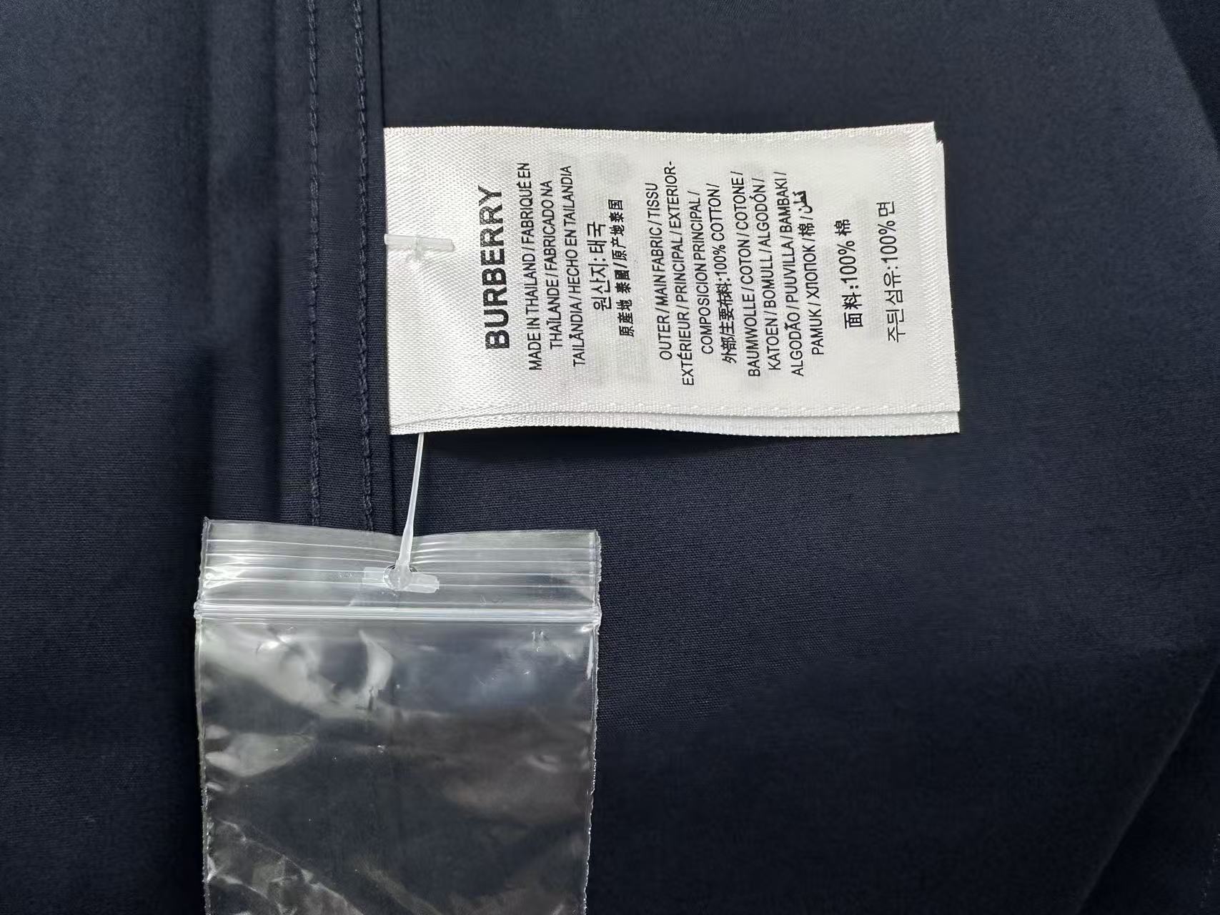 Burberry shirt care label and size tag on dark navy collar