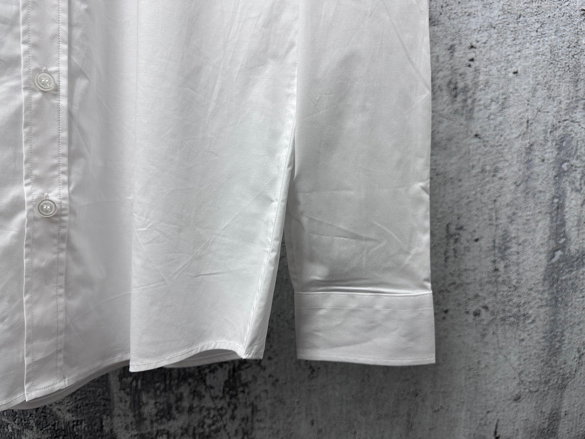 Burberry long-sleeve shirt, white, side view with curved hem