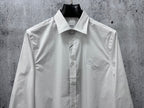 White long-sleeve button-up shirt with logo on left chest