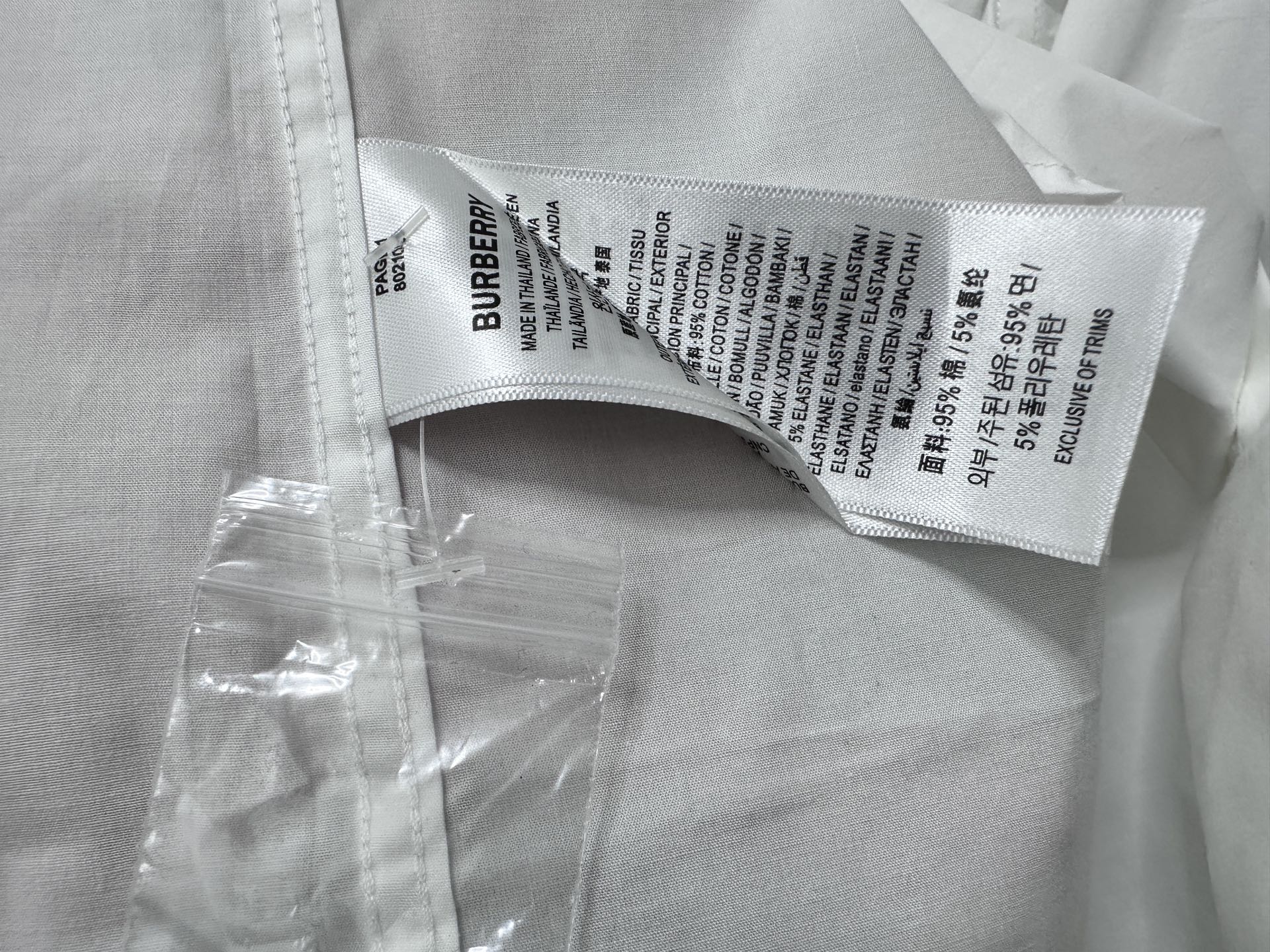 Burberry care label inside white shirt neck with printed sizing text