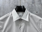 White long-sleeve shirt with pointed collar and center-front buttons
