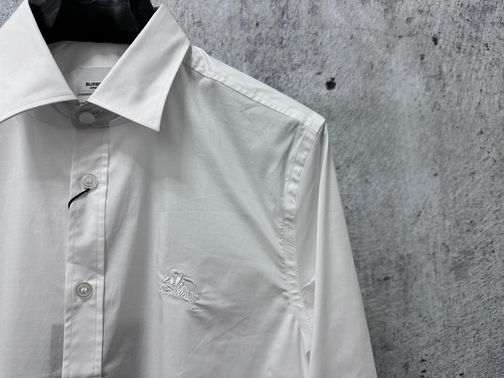 White button-up shirt with pointed collar and left chest logo detail