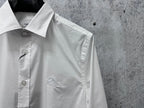 White button-up shirt with pointed collar and left chest logo detail