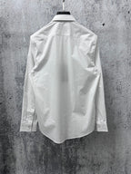 White long-sleeve shirt back view with yoke seam and side panels