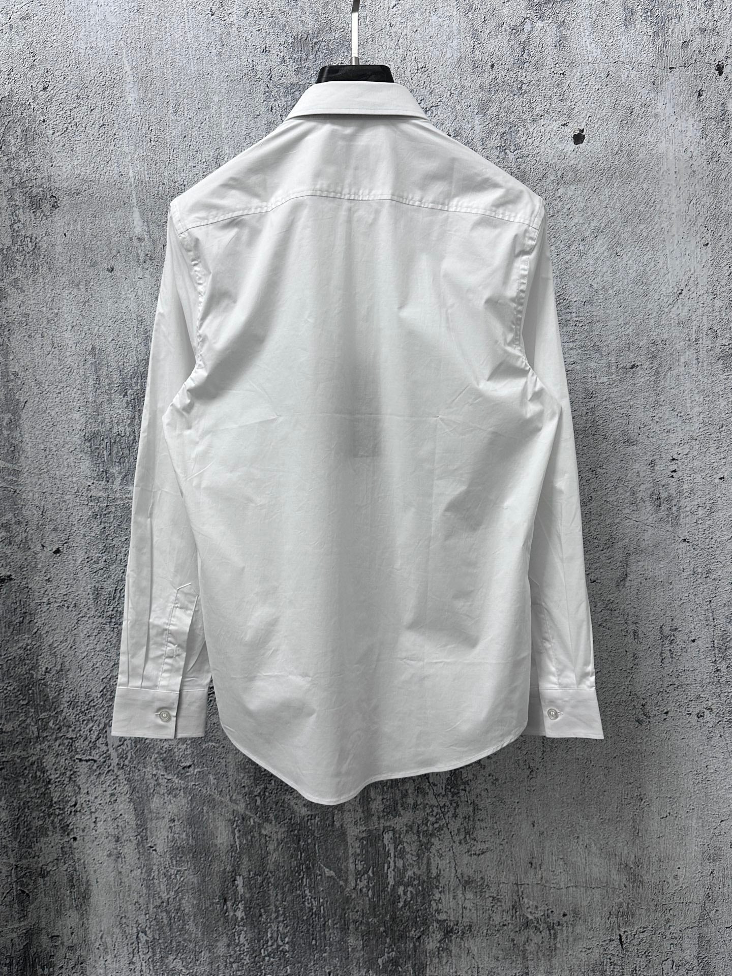 White long-sleeve shirt back view with yoke seam and side panels