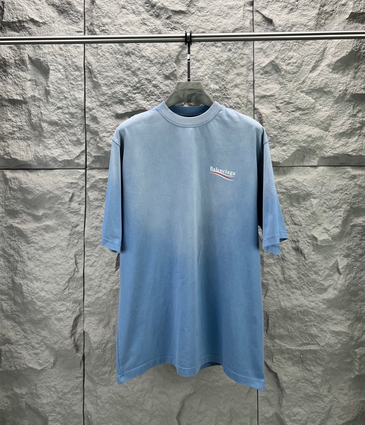 Light blue short-sleeve T-shirt with Balenciaga logo on the front chest.