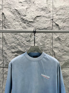 Light blue short-sleeve T-shirt with small Balenciaga logo on the front chest.