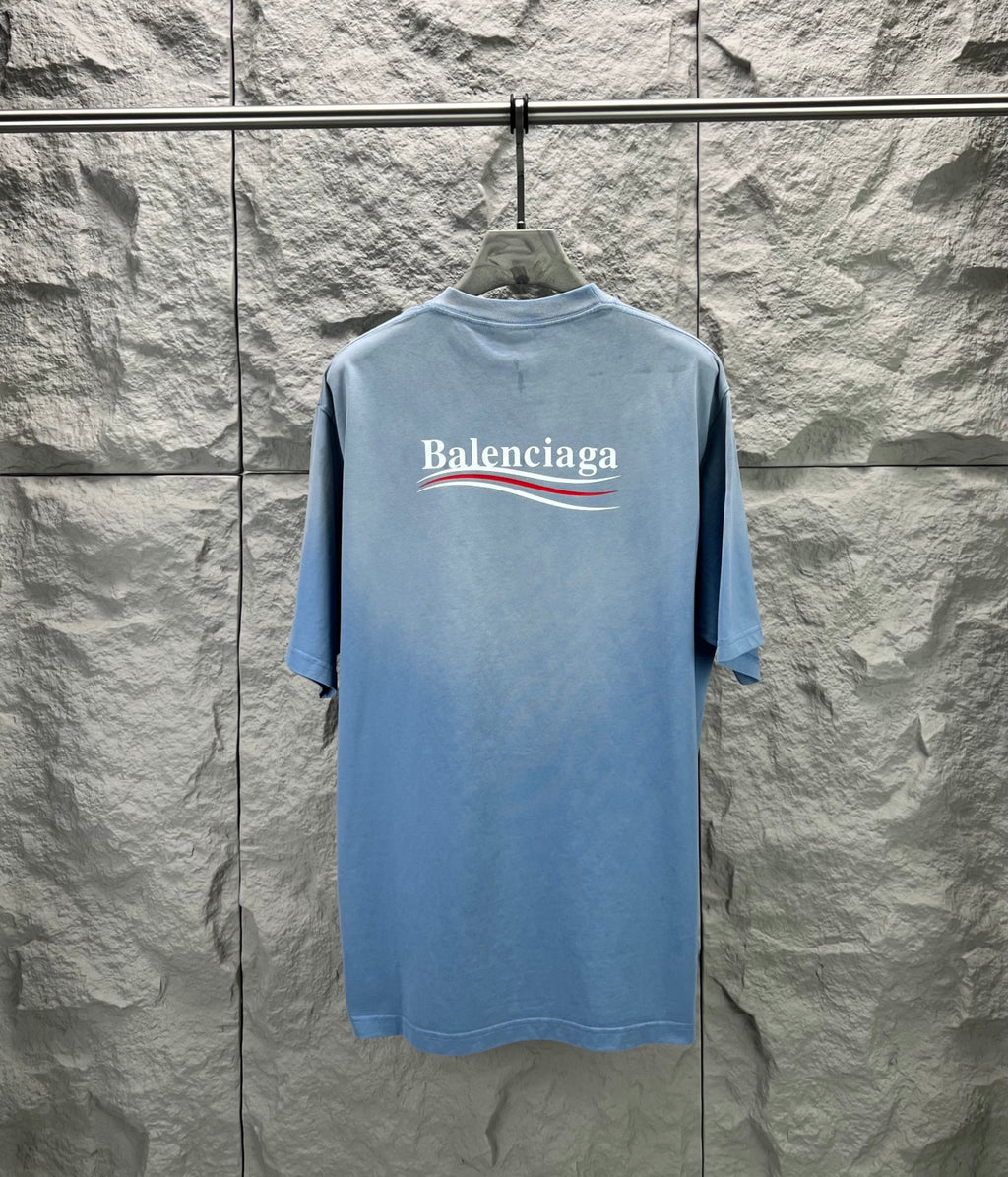 Light blue short-sleeve T-shirt with Balenciaga logo on the back neckline area.
