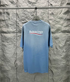 Light blue short-sleeve T-shirt with Balenciaga logo on the back neckline area.